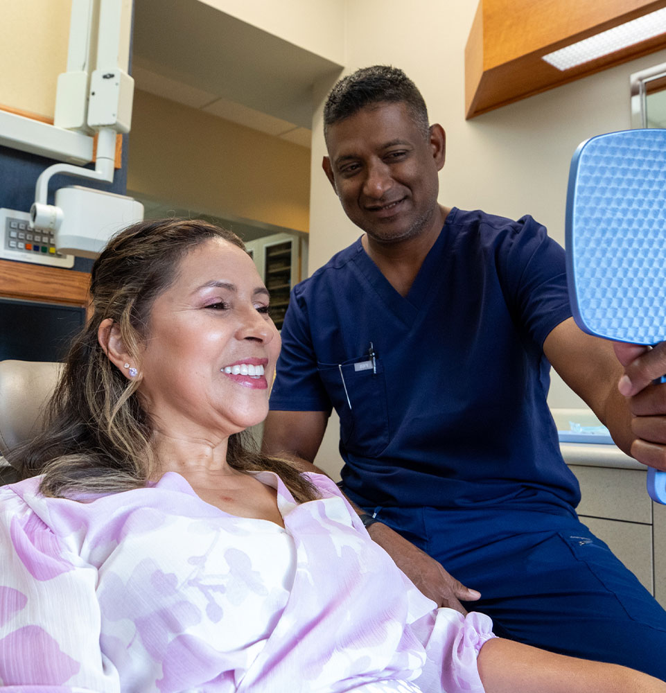 teeth in a day patient admiring her new smile